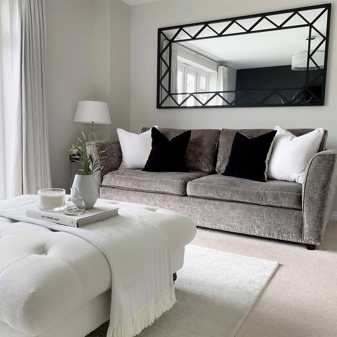 A Living Room with a Grey Velvet Sofa and Grid Mirror