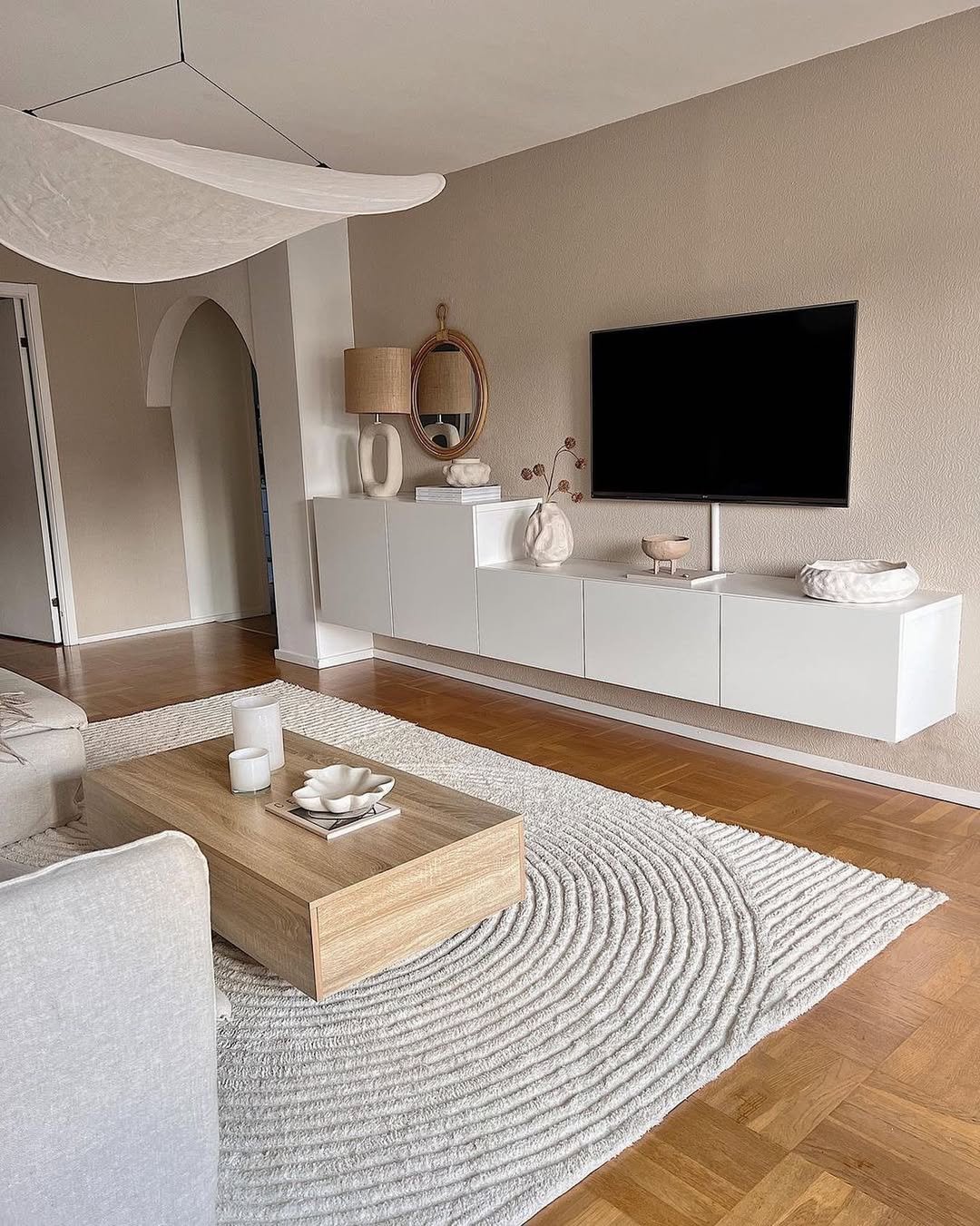 Greige Plaster TV Wall with Arched Doorway