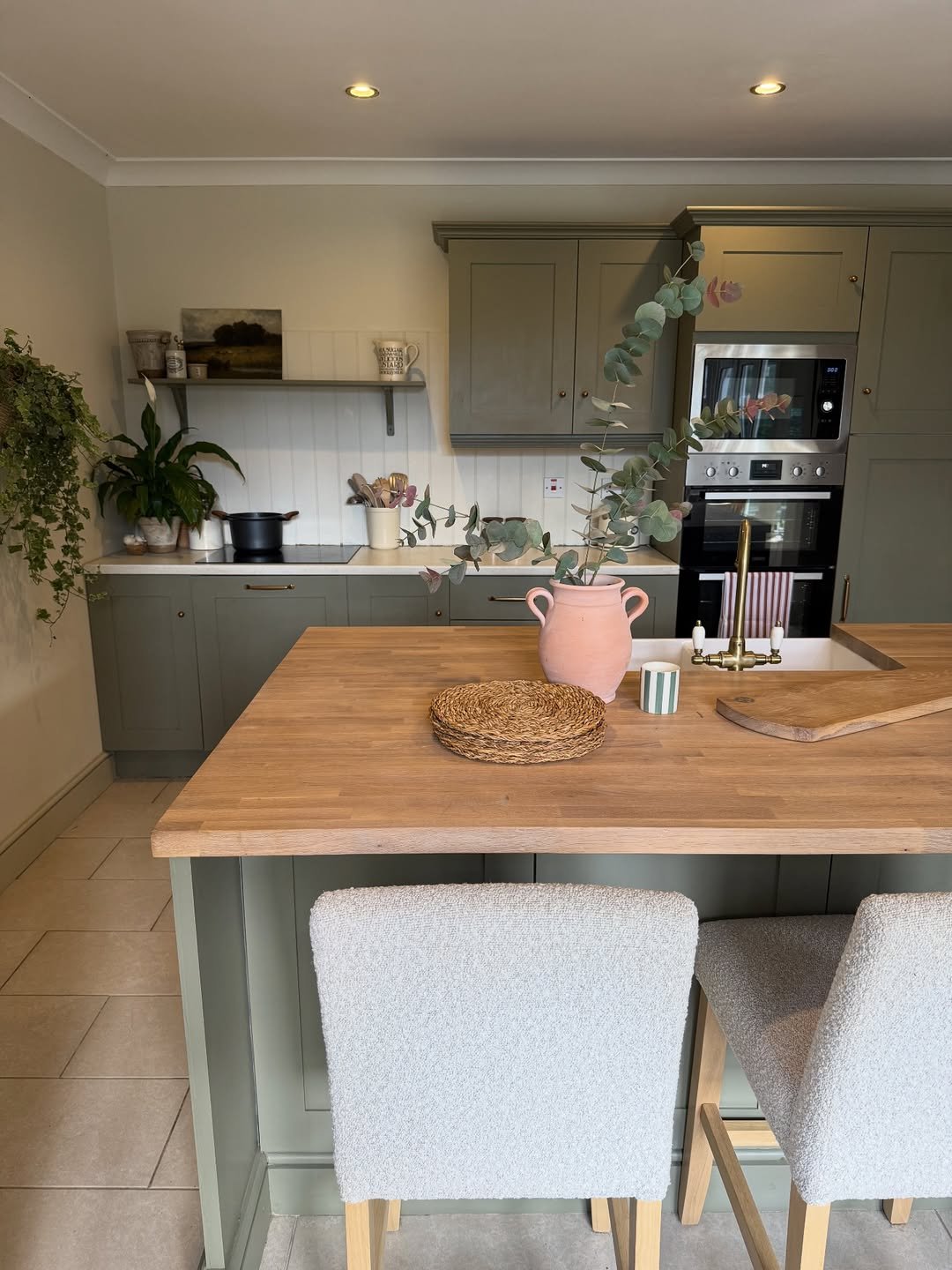 Matte Chalky Sage Green Cabinetry and Two Boucle Stools for Counter Seating