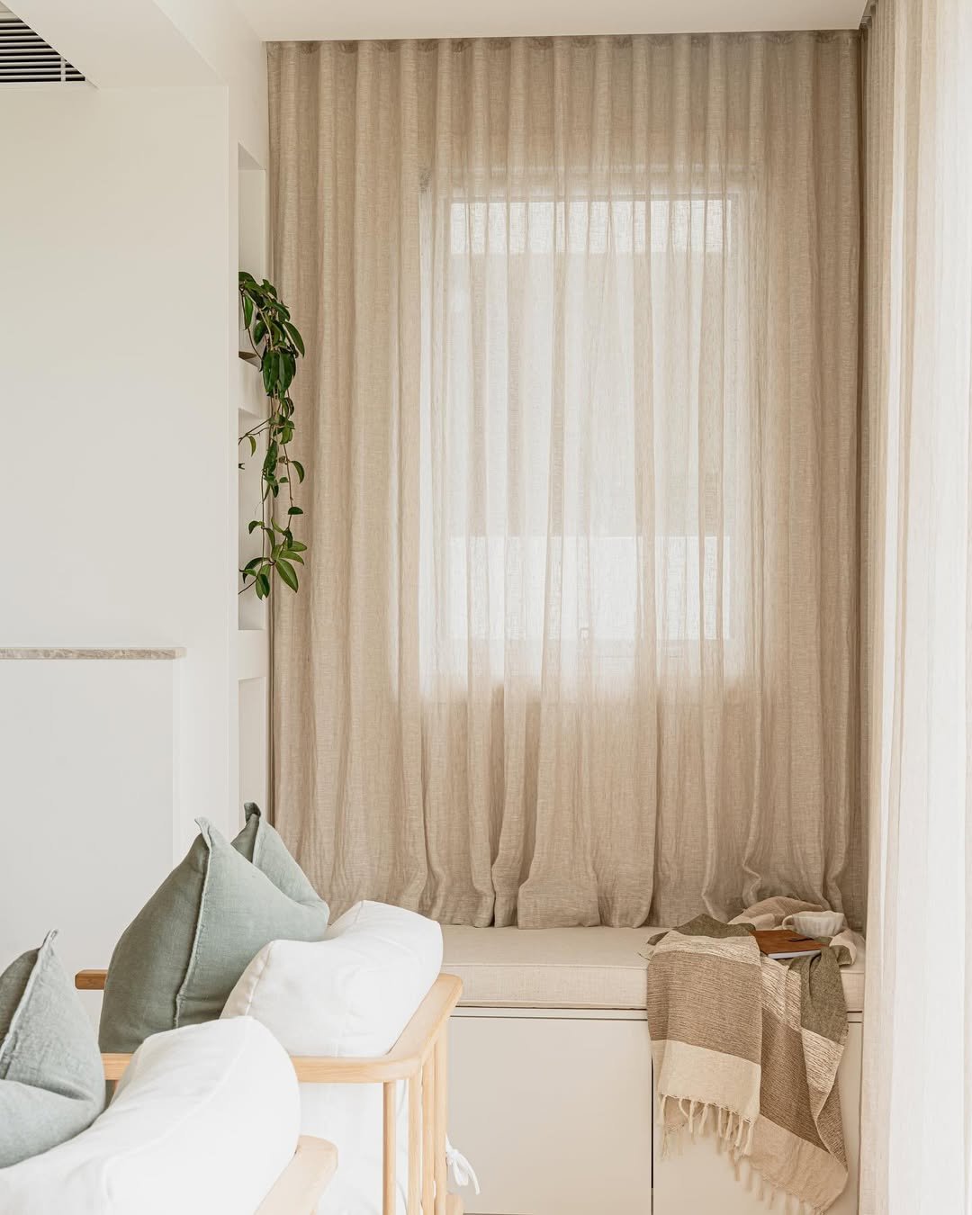 Natural Linen Curtains Around a Window Seat