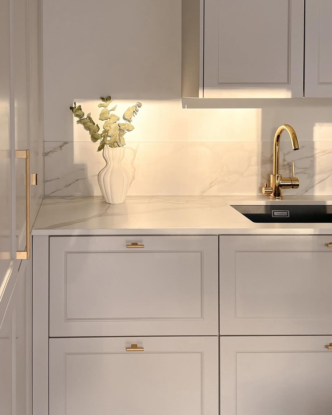 Pearl Beige Cabinetry with Gold Veined Marble