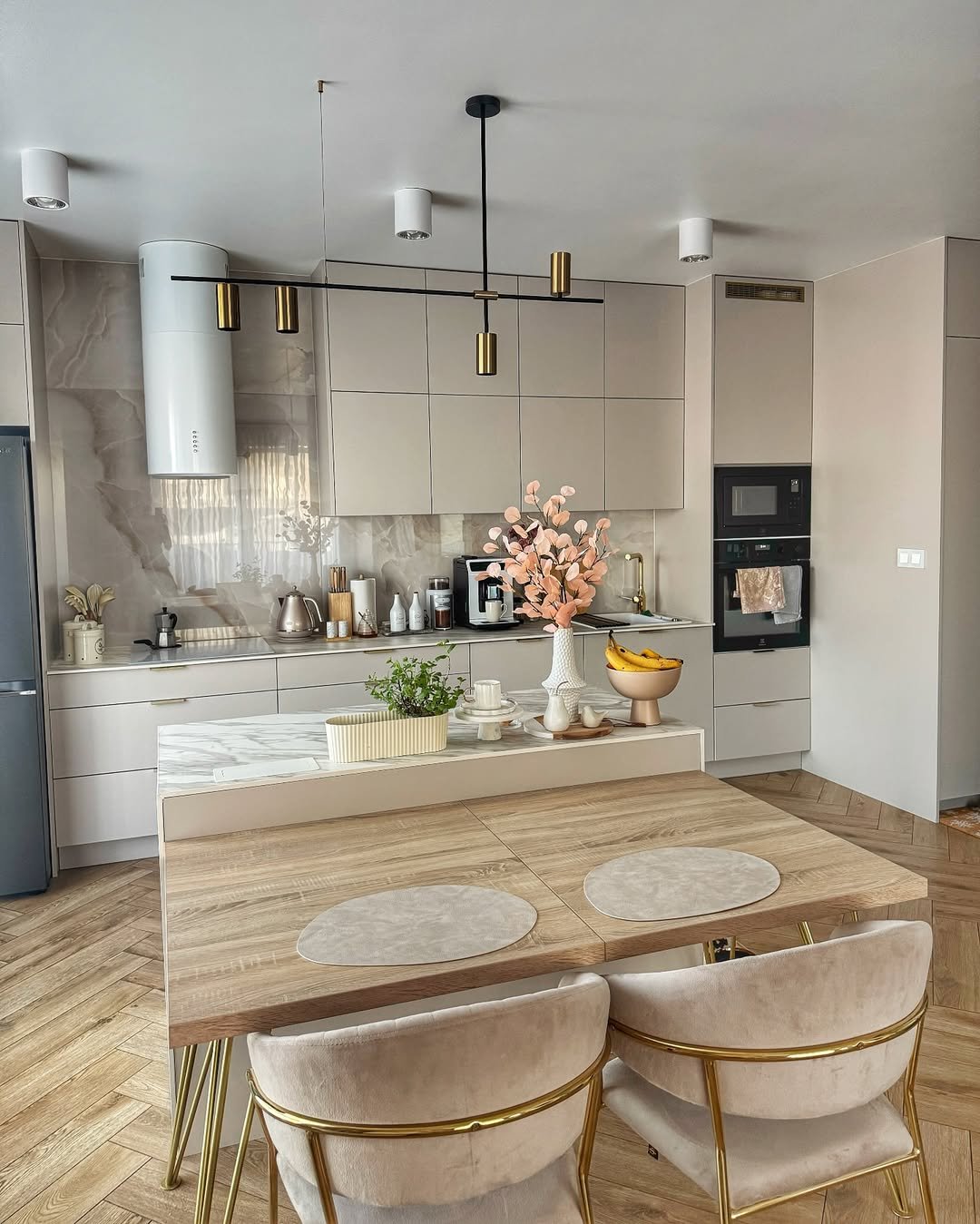 Quiet Luxury Kitchen with White Shaker Cabinetry, Walnut Range Nook, Rattan Island Stools and Linear Black Brass Pendant