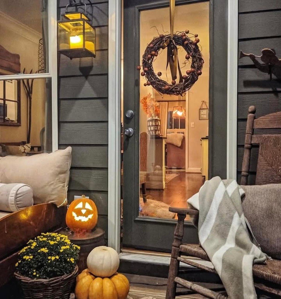 Softly Lit Front Door with Wreath and Pumpkins