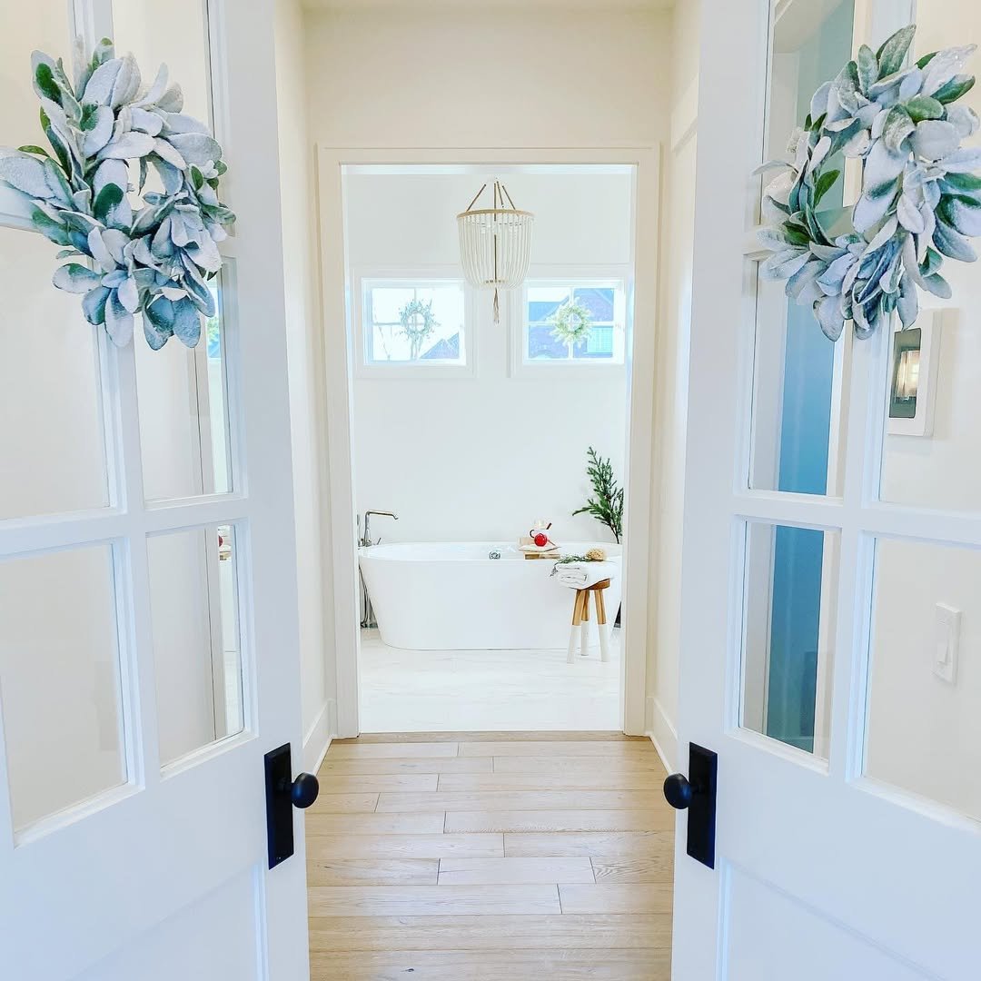 Two French Doors to a White Spa Bathroom