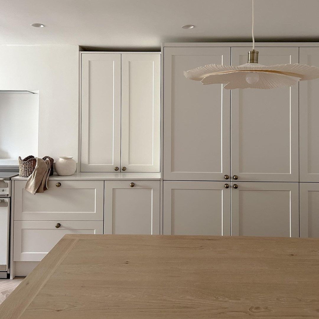 Warm Greige Shaker Cabinetry with Brass and Raw Oak
