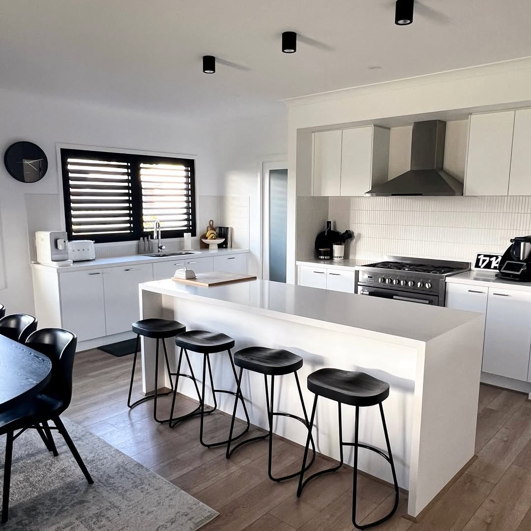 White Kitchen with Black Stools